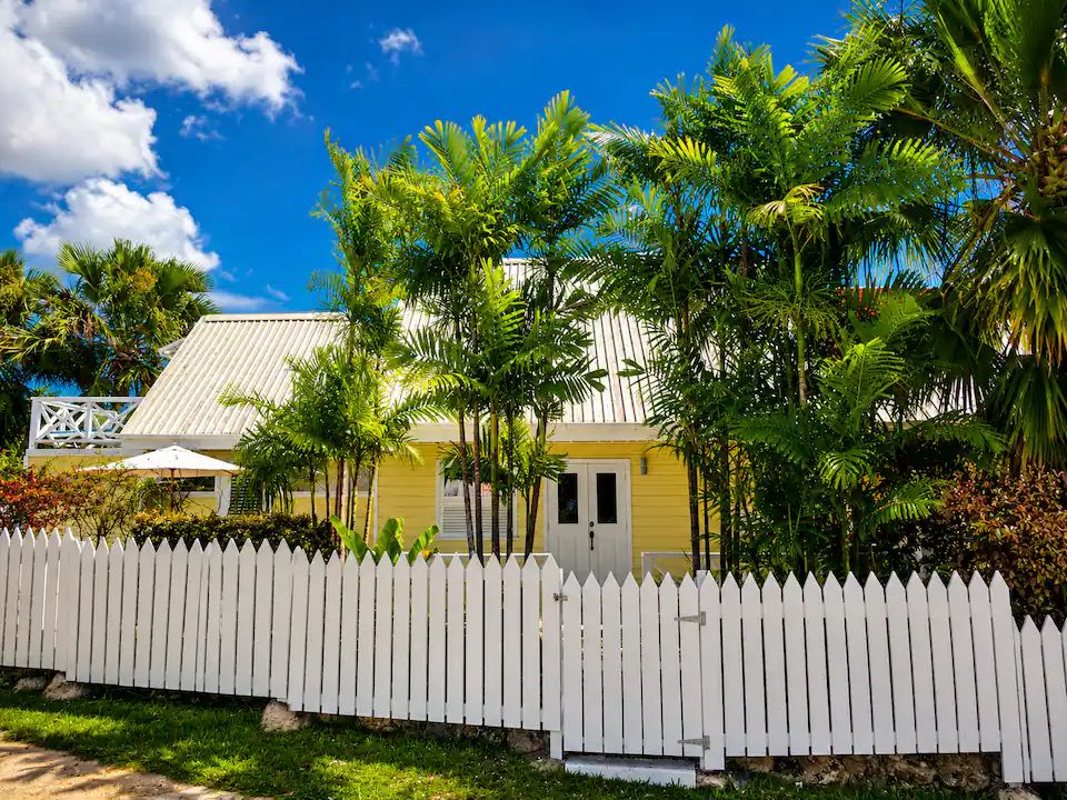 Lime Cottage Barbados — yellow chattel villa behind white picket fence