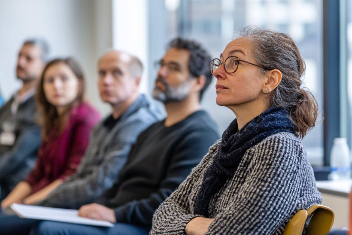 Team members attentively listening in a partner meeting